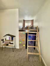 Carpeted bedroom with baseboards