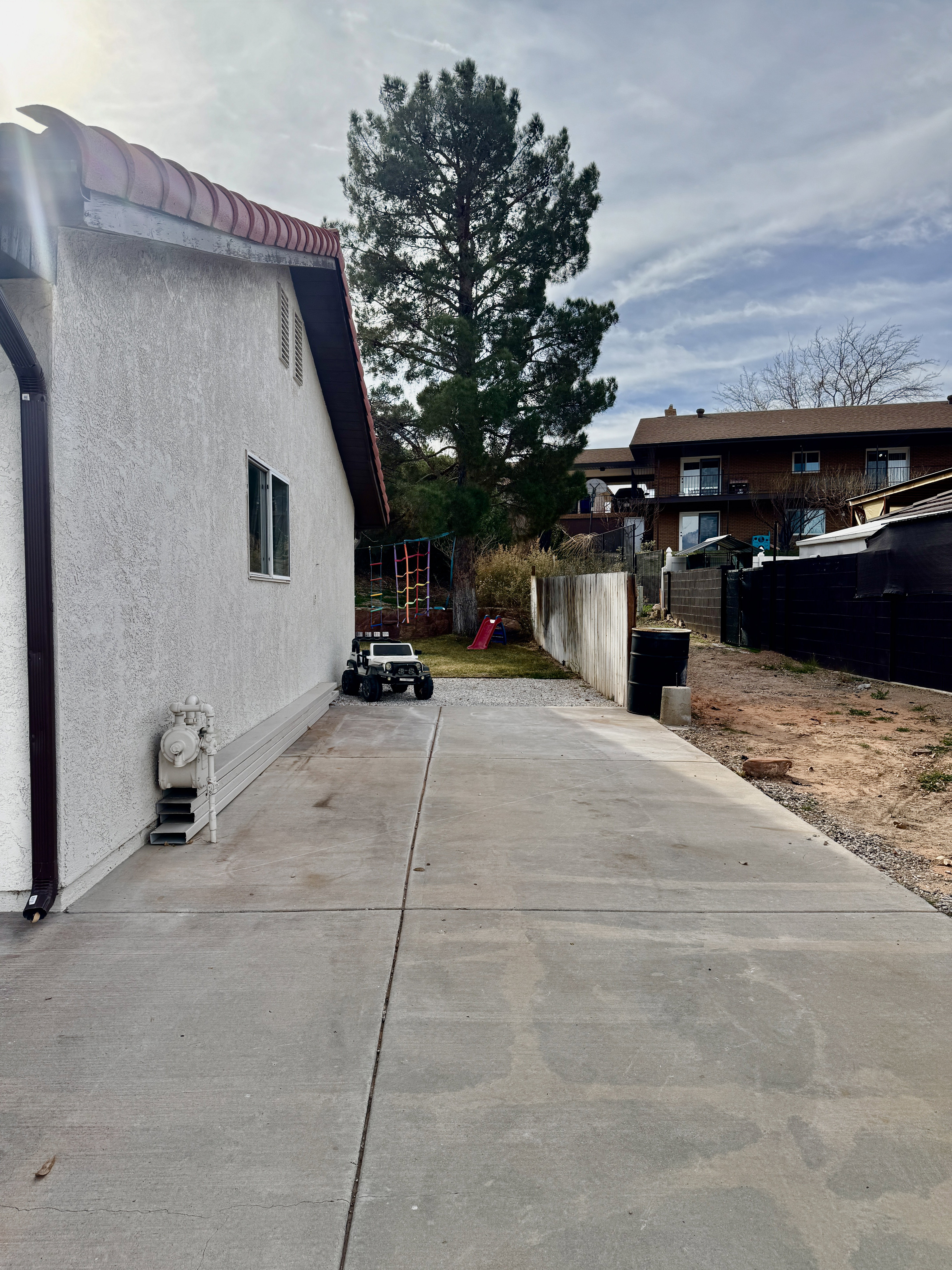 View of side of property featuring stucco siding RV Parking