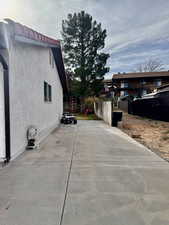 View of side of property featuring stucco siding RV Parking