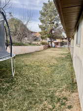 Fenced backyard with a trampoline