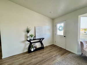 Entrance foyer with wood finished floors and baseboards