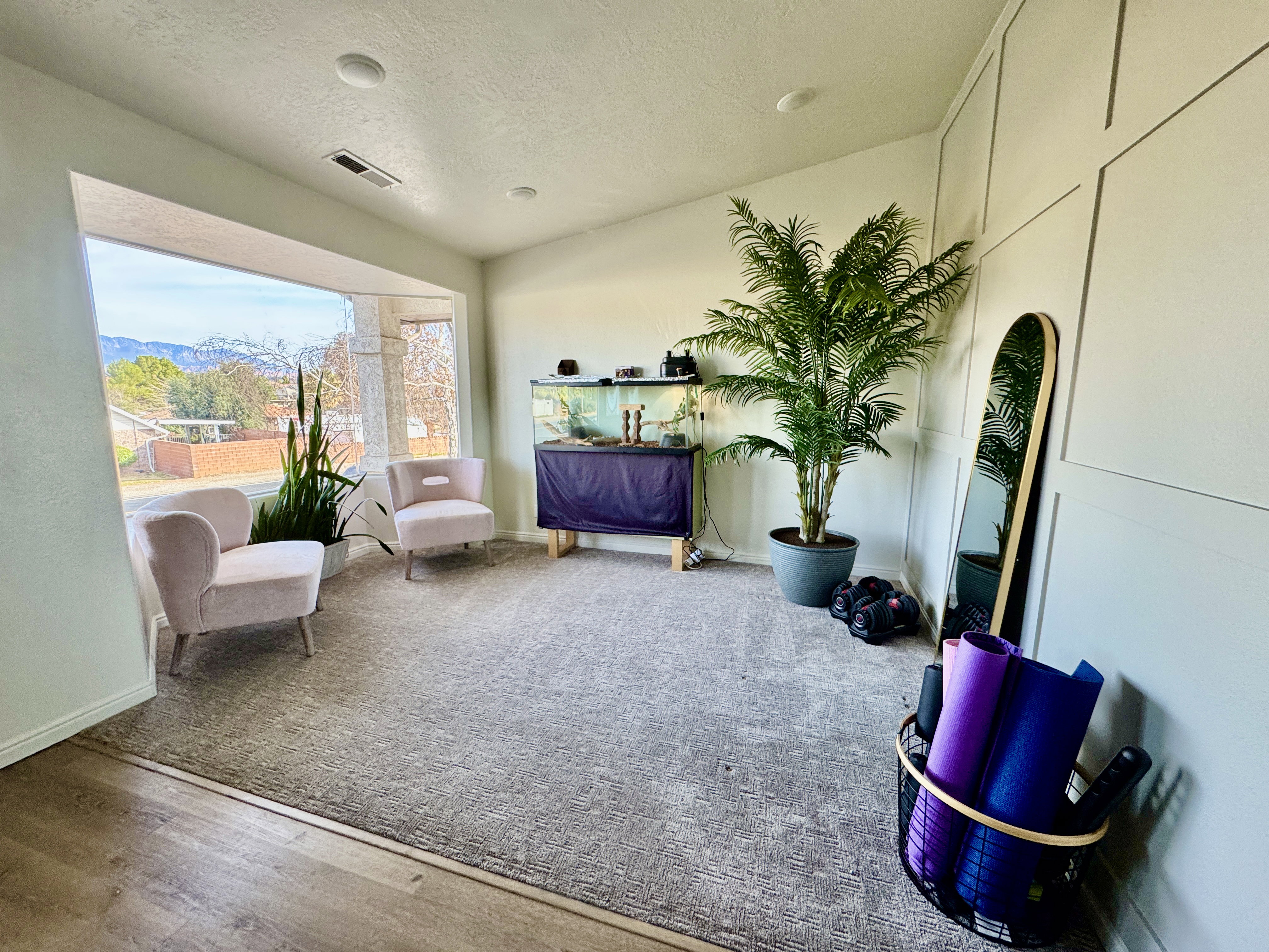 Living area featuring a textured ceiling and wood finished accent wall