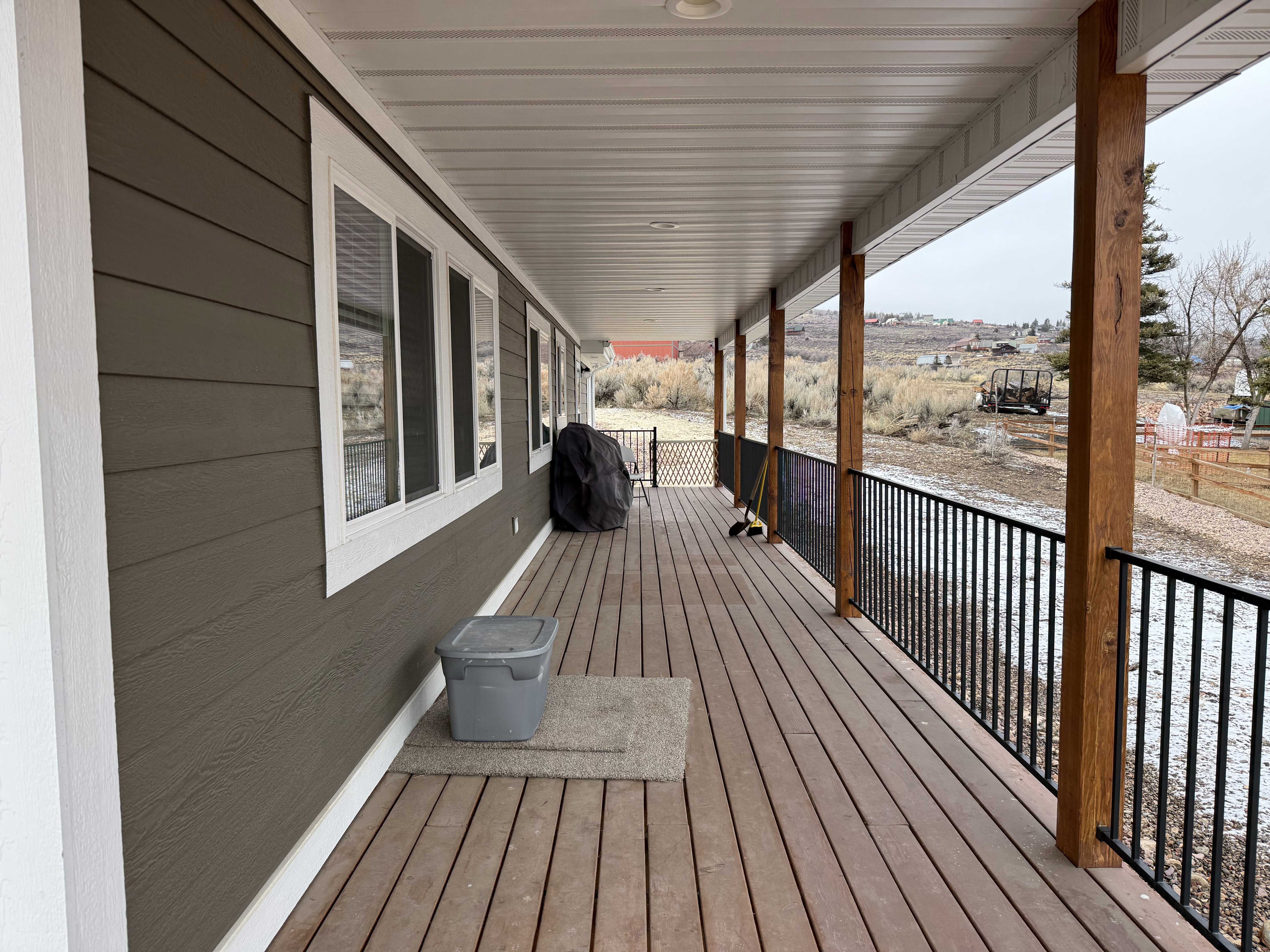 Wooden porch featuring area for grilling
