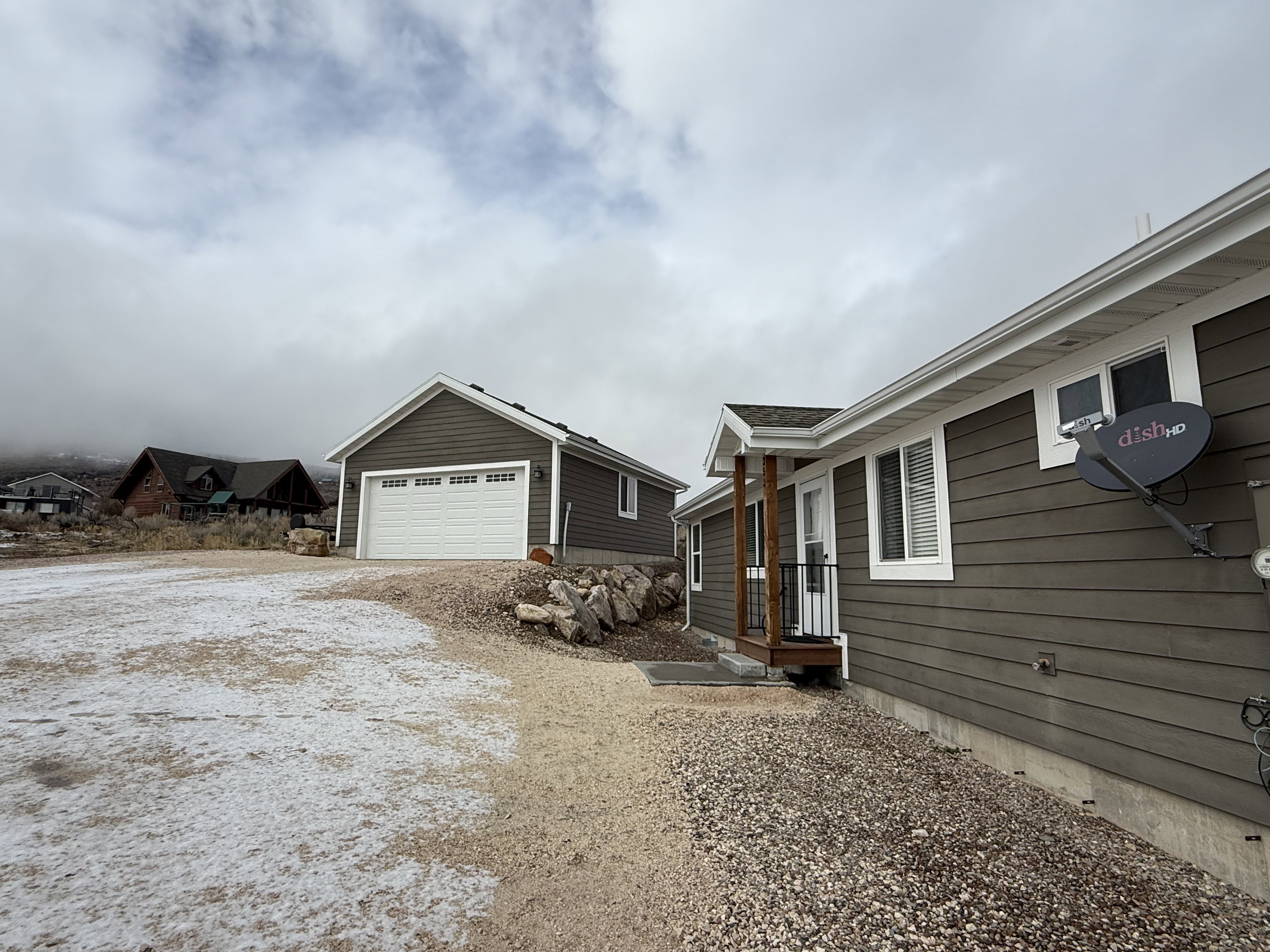 View of home's exterior featuring a garage and driveway