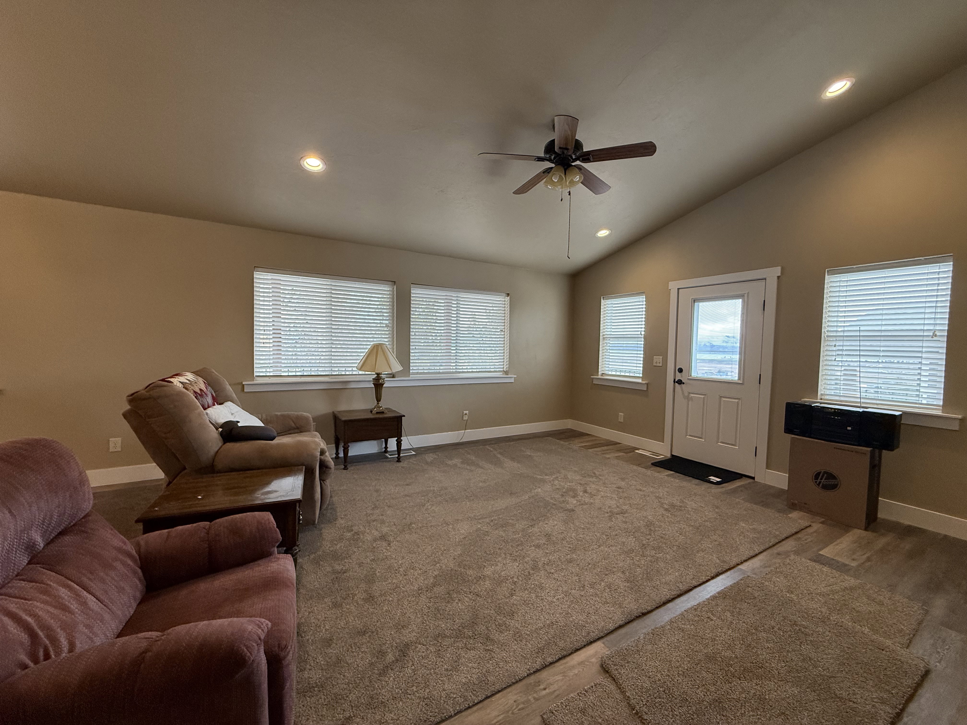 Living area featuring recessed lighting, ceiling fan, carpet flooring, and vaulted ceiling