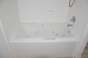 Full bathroom featuring a combined bath / shower with jetted tub