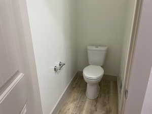 Bathroom featuring toilet and light wood-style floors