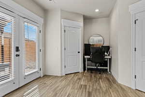 Office featuring light wood finished floors and french doors