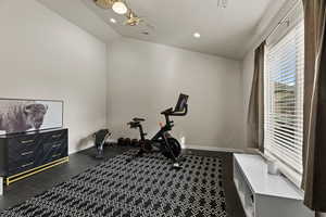 Exercise room with vaulted ceiling and recessed lighting