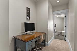 Office space with recessed lighting and carpet floors