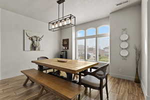 Dining area with wood finish floors and a textured ceiling