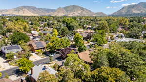 Aerial overview of property's location with a mountainous background and nearby suburban area