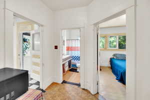 Corridor featuring parquet flooring and baseboards