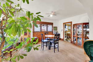 Dining room featuring a ceiling fan and light wood-type flooring