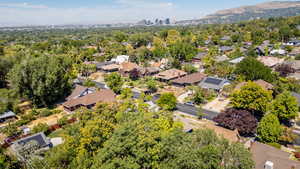 Aerial view of property's location with a mountainous background and nearby suburban area