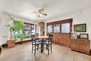 Dining space featuring a ceiling fan and light wood-type flooring