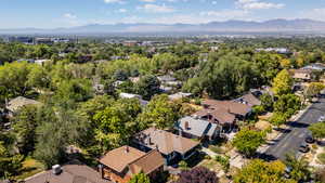 Aerial overview of property's location featuring a mountainous background and nearby suburban area