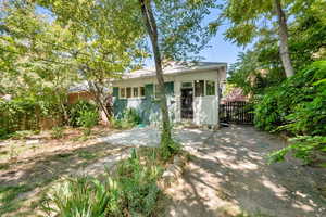 View of front of house with a fenced backyard and brick siding