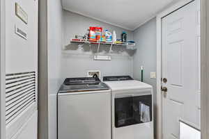 Laundry area with a heating unit and washing machine and clothes dryer