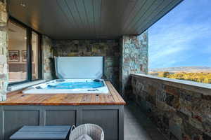 Patio / terrace with a covered hot tub