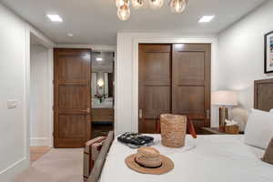 Carpeted bedroom featuring a closet and baseboards