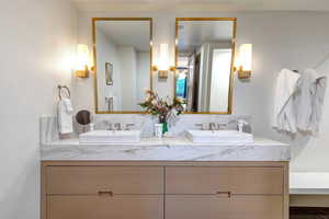 Full bath featuring double vanity