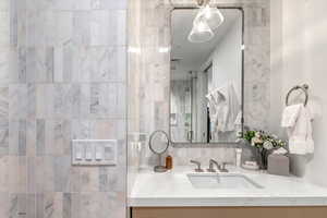 Full bathroom featuring vanity and a stall shower