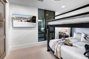 Bedroom featuring carpet flooring and baseboards