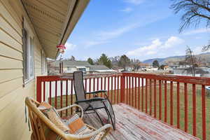Wooden terrace featuring a yard and a residential view