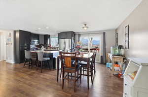 Dining space featuring dark wood-style floors, recessed lighting, and a textured ceiling