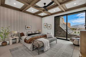 Carpeted bedroom with access to outside, a mountain view, coffered ceiling, and ceiling fan