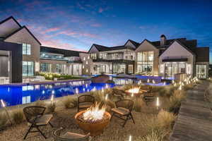 Swimming pool featuring an outdoor fire pit, a balcony, and a patio