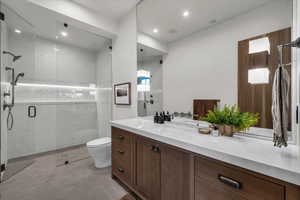 Full bath with vanity, a stall shower, and recessed lighting