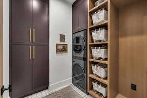 Laundry room with cabinet space and stacked washer and dryer