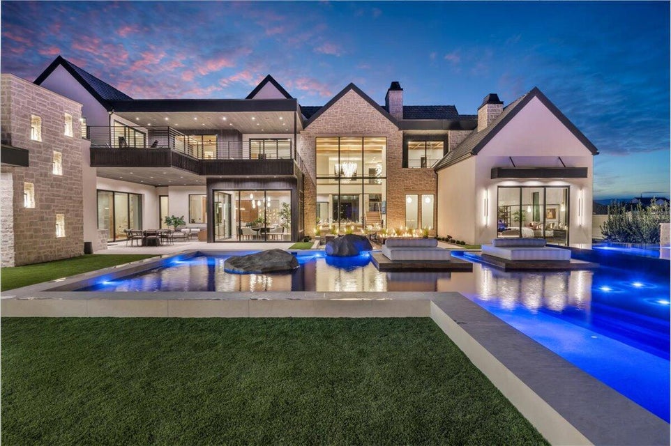 Back of property featuring a balcony, an outdoor pool, a chimney, and a patio area