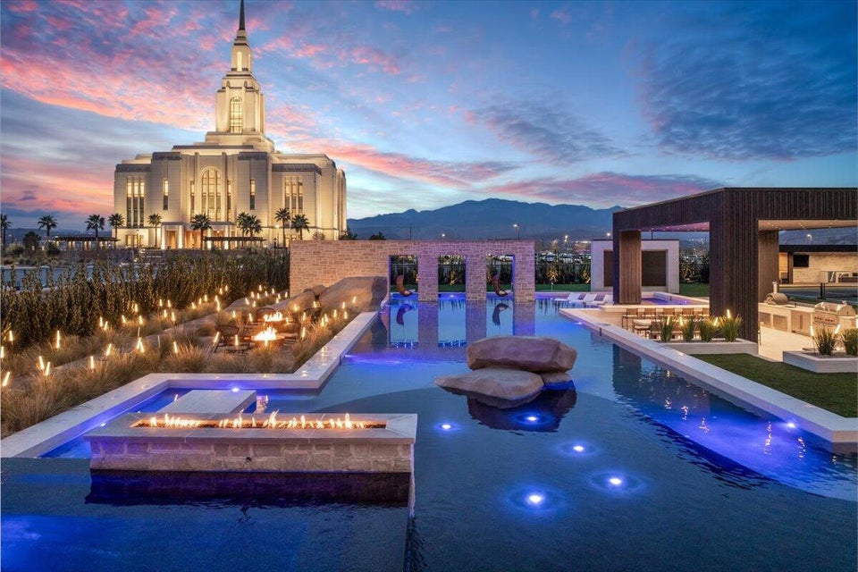 Pool at dusk with an outdoor fire pit, an outdoor pool, a mountain view, and a patio