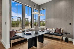 Dining room featuring light wood finished floors and a high ceiling
