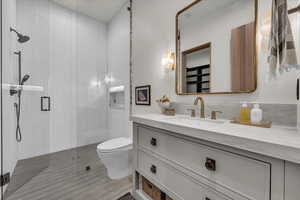 Bathroom featuring a stall shower and vanity