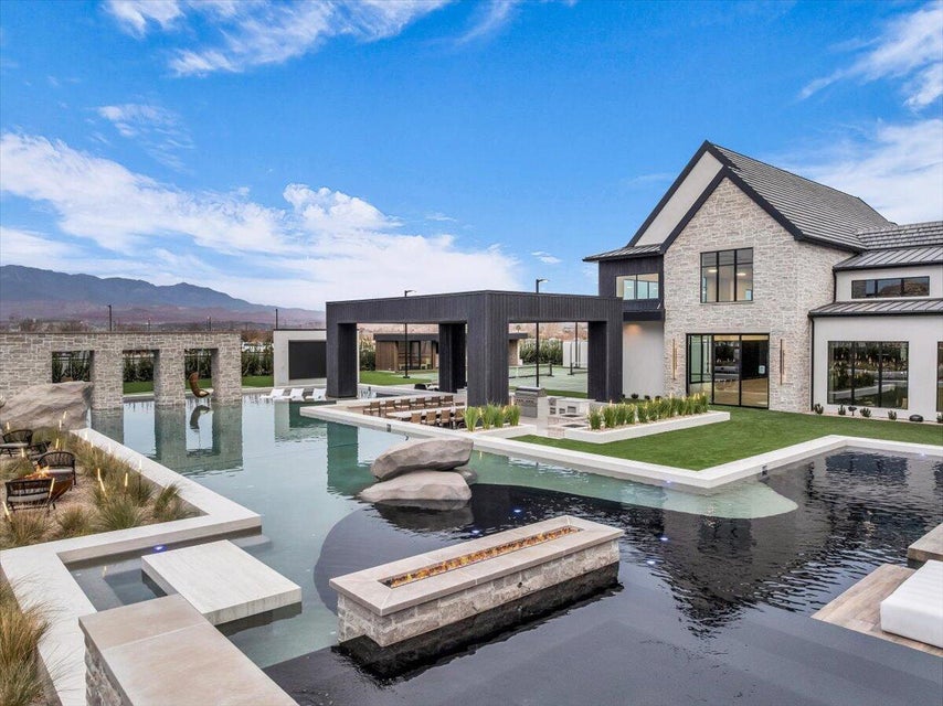 Outdoor pool featuring a mountain view and a patio
