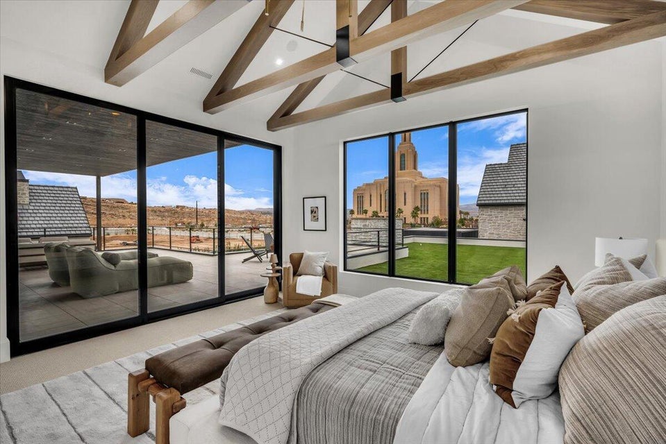 Carpeted bedroom with lofted ceiling and access to outside