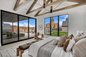 Carpeted bedroom with lofted ceiling and access to outside