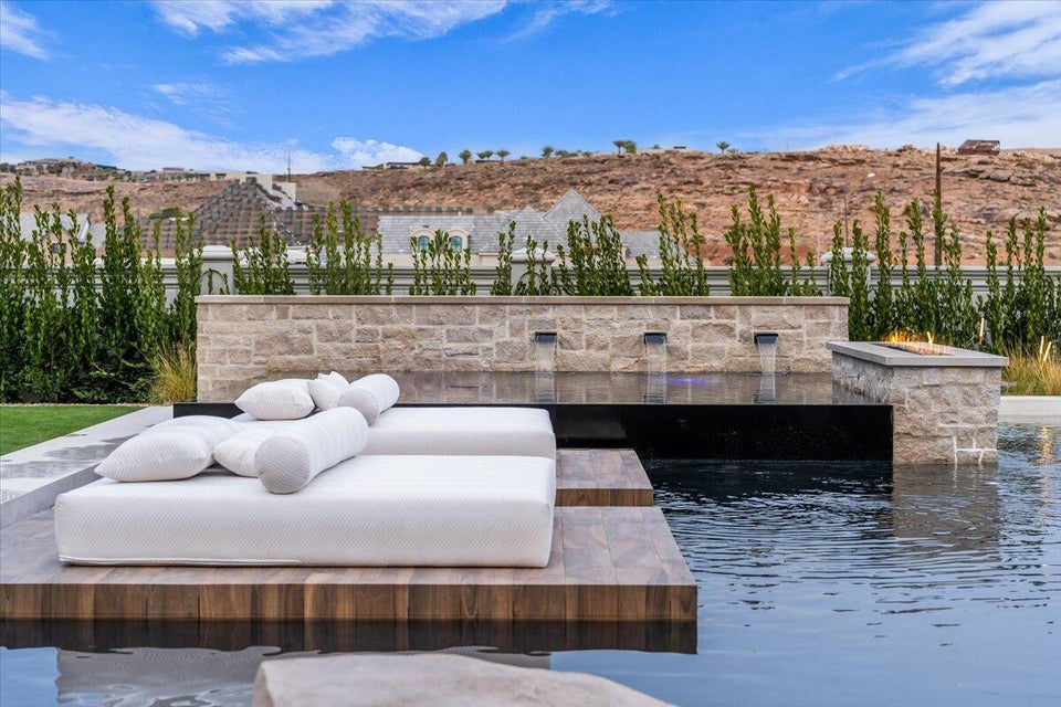 View of patio with a water view and outdoor lounge area