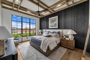 Bedroom with coffered ceiling, wood finished floors, a residential view, and a ceiling fan
