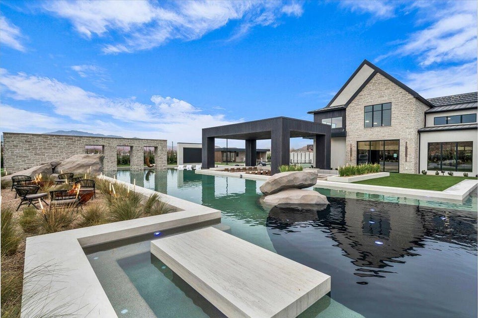 Outdoor pool featuring a patio and a jacuzzi