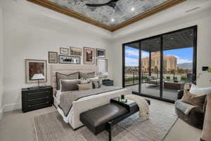 Bedroom with carpet floors, a raised ceiling, access to exterior, ornamental molding, and a ceiling fan