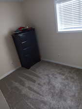 Bedroom 1 featuring carpet floors; dresser included
