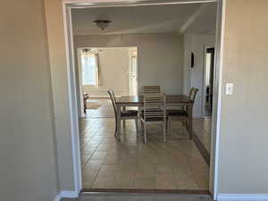 Dining area with light tile patterned flooring