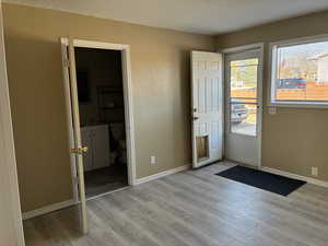 Doorway to backyard featuring laminate  finished floors and ready for your vision