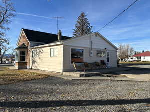 Back view of home featuring a back patio