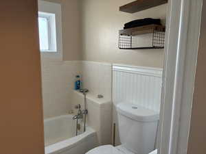 Bathroom with a bath and hand held shower attachment